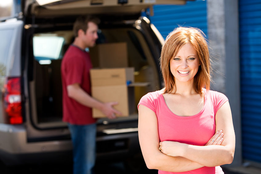 People unloading boxes from vehicle